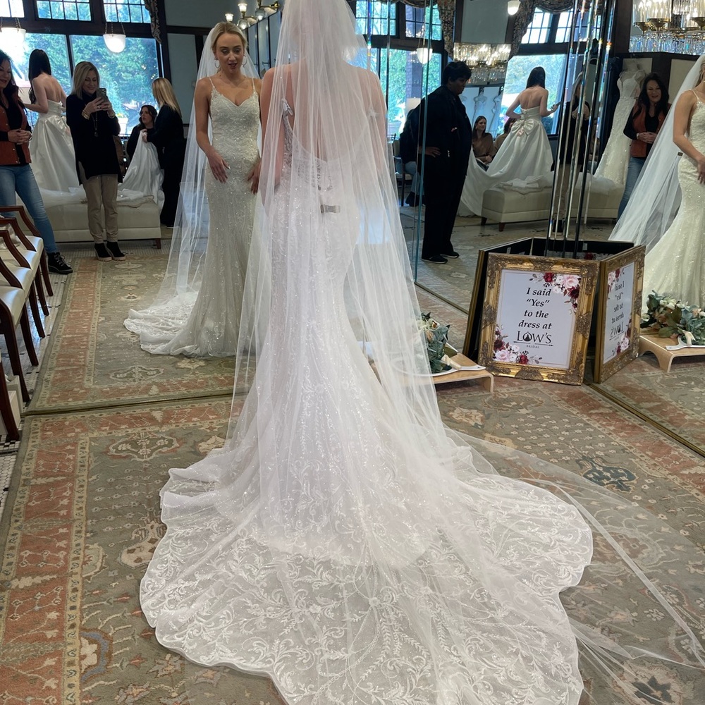 Size 2 beautiful beaded wedding gown with iconic train.